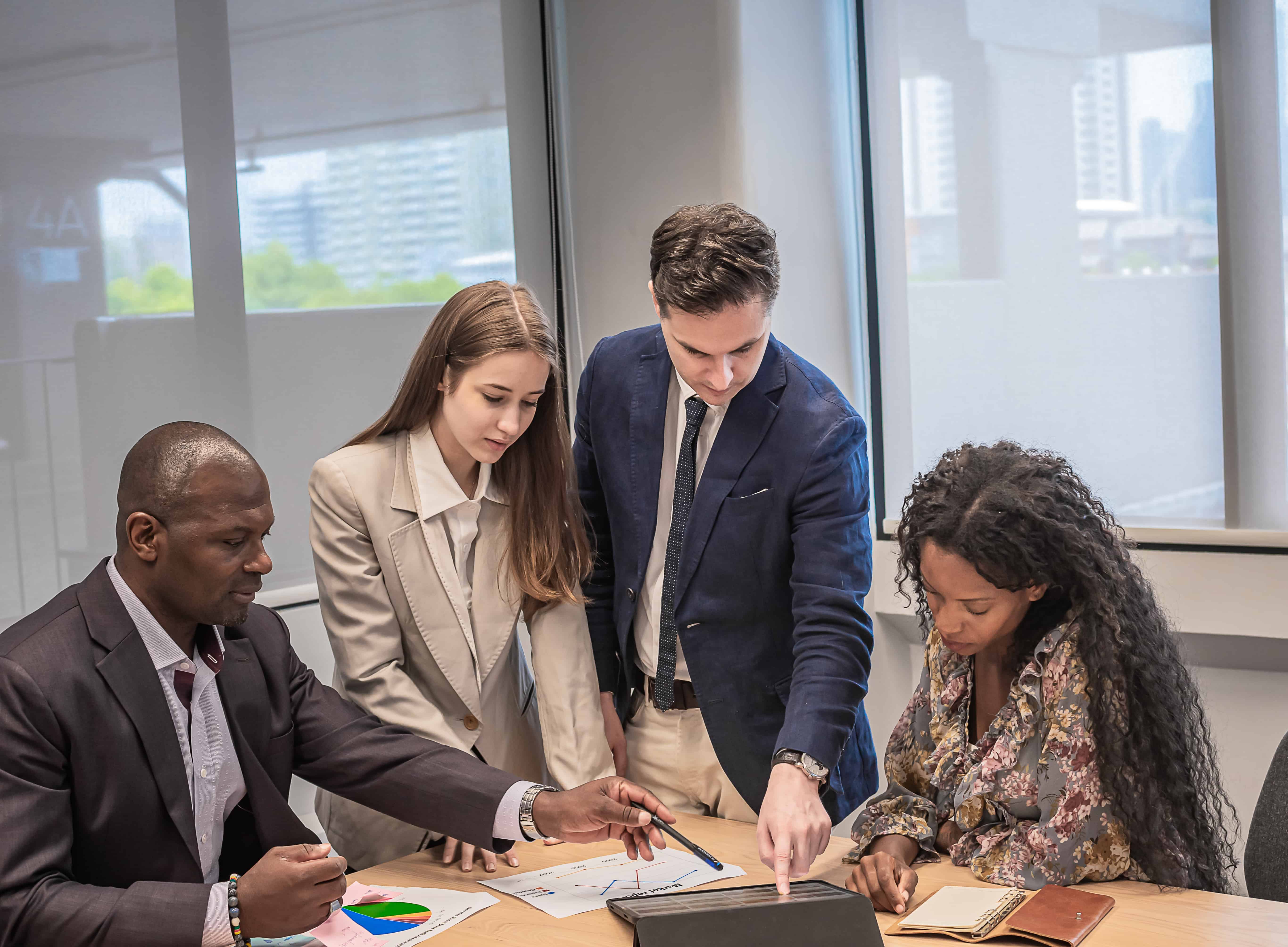 Business professionals reviewing work together during a management meeting