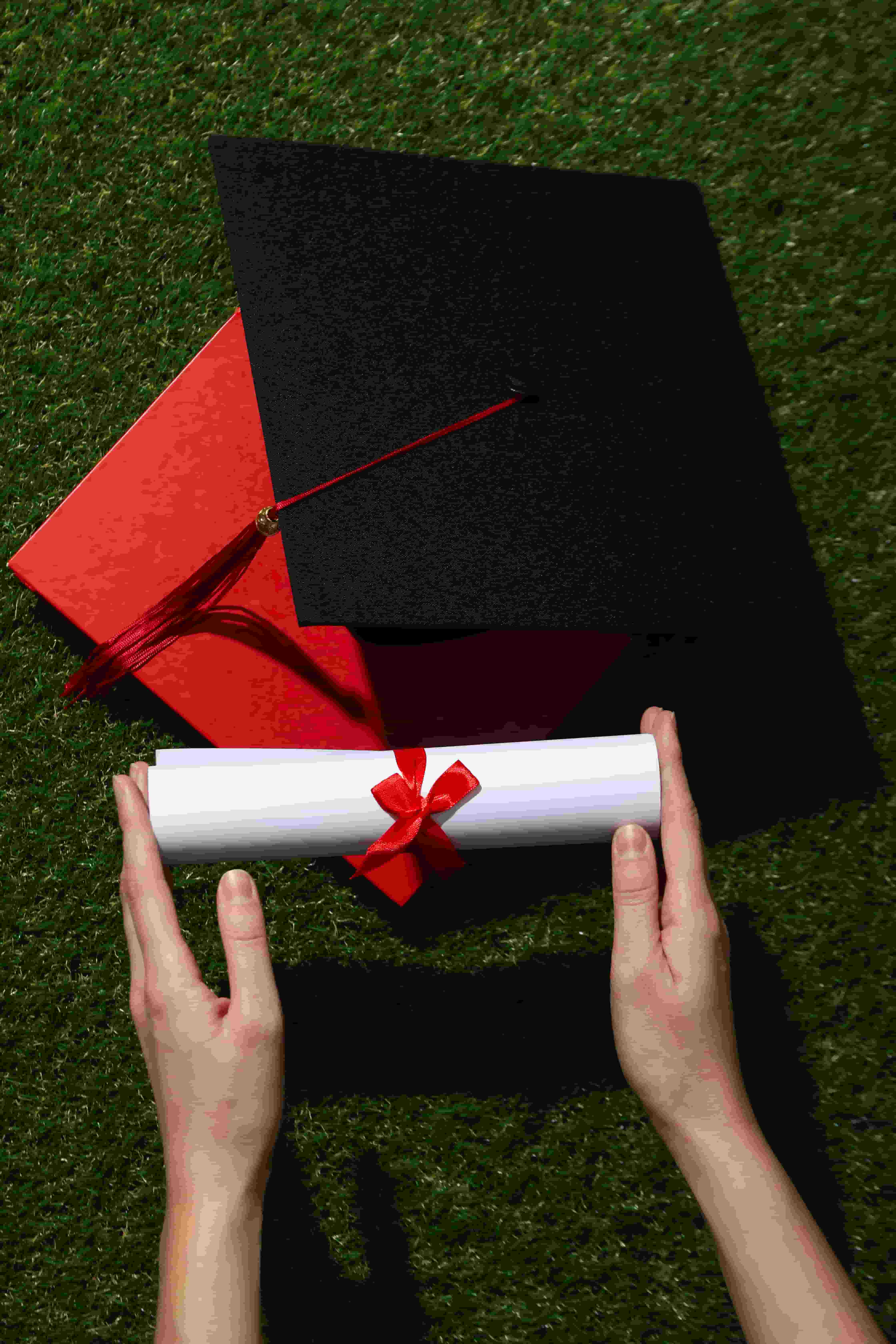 Graduate holding a diploma and graduation cap