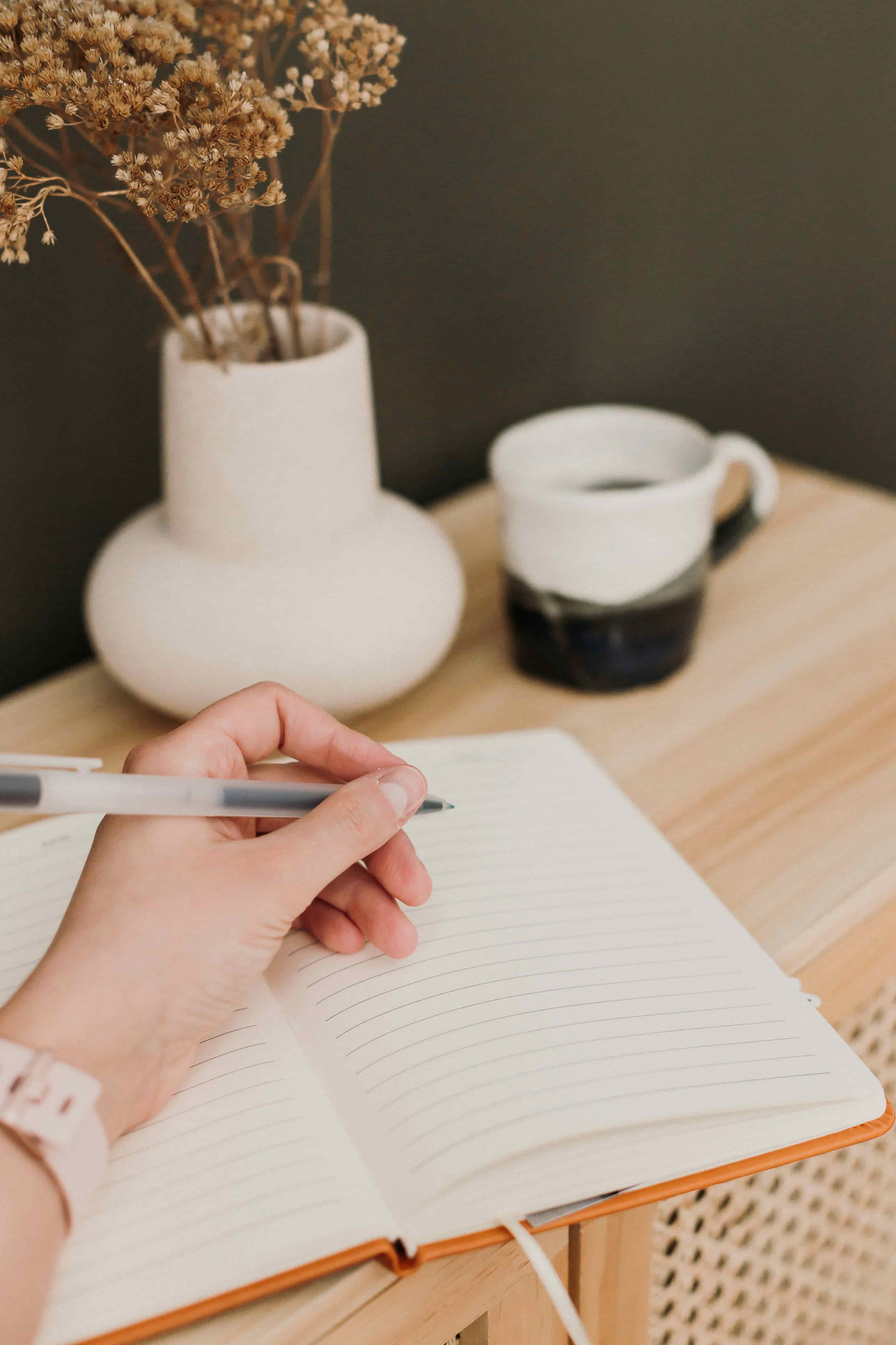A professional making notes in a notebook