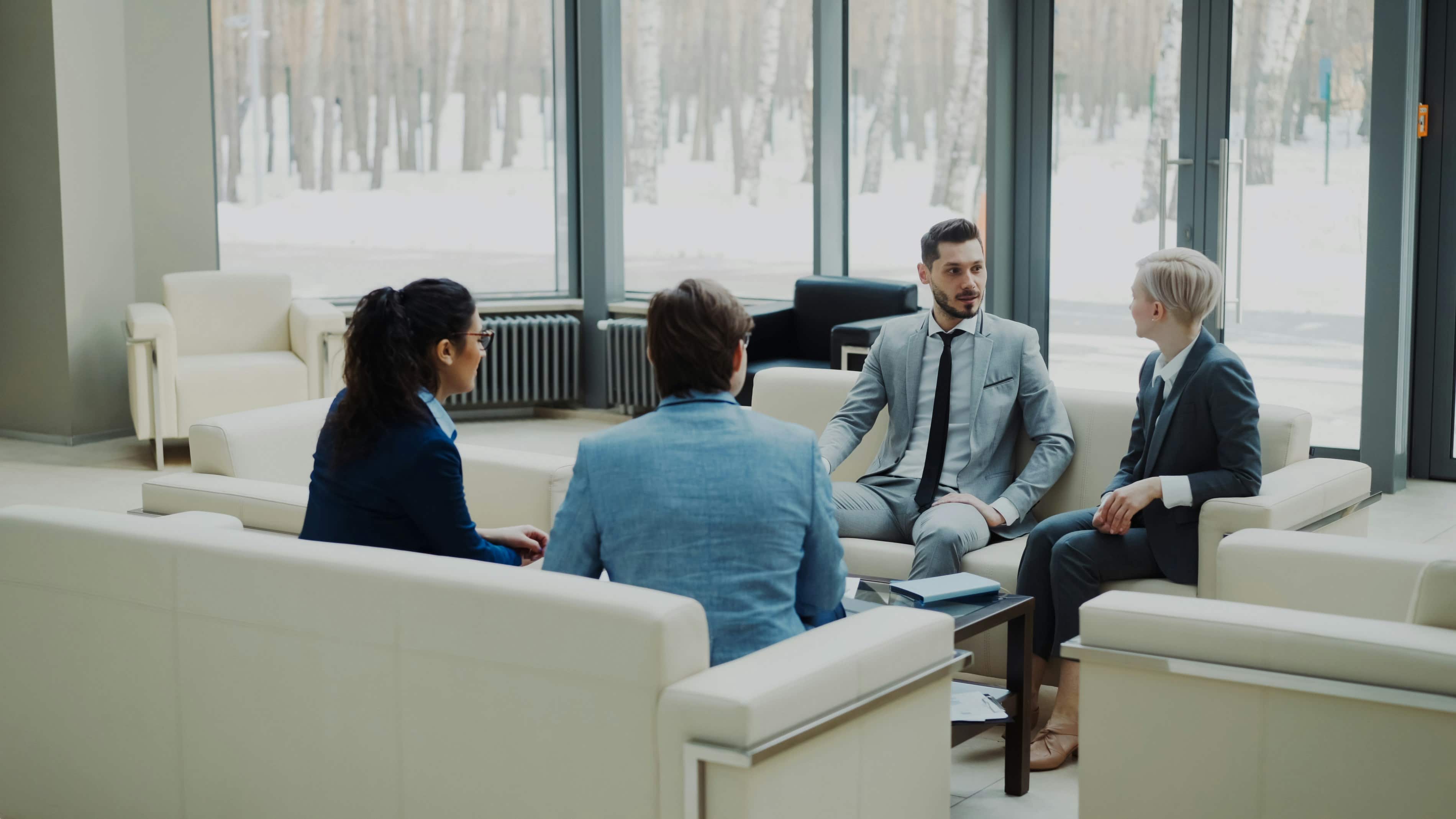 Working professionals discussing their ATHE diploma studies in a modern office